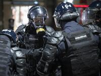 Police officers wear gas masks and anti-riot gear after firing tear gas against protesters as they clash with police during the rally against government’s coronavirus restrictions in Ljubljana on November 5, 2020. Jure Makovec / AFP