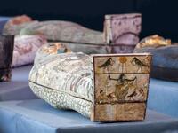 A picture shows wooden sarcophagi during the unveiling of an ancient treasure trove of more than a 100 intact sarcophagi, at the Saqqara necropolis 30 kms south of the Egyptian capital Cairo, on November 14, 2020. Egypt announced the discovery of an ancient treasure trove of more than a 100 intact sarcophagi, the largest such find this year. The sealed wooden coffins, unveiled on site amid fanfare, belonged to top officials of the Late Period and the Ptolemaic period of ancient Egypt. They were found in thr