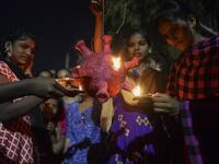 Students from a government girls hostel prepare to burn a Covid-19 coronavirus model during Diwali, the Hindu Festival of Lights, in Hyderabad on November 14, 2020. NOAH SEELAM / AFP