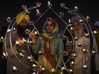 Sikh devotees light candles on the occasion of Bandi Chhor Divas, a Sikh festival coinciding with Diwali, the Hindu festival of Light, at the Golden Temple in Amritsar on November 14, 2020. NARINDER NANU / AFP