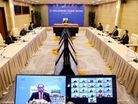 This picture taken and released by the Vietnam News Agency on November 20, 2020 shows Vietnam's Prime Minister Nguyen Xuan Phuc (C) in Hanoi, taking part in the virtual meeting between world leaders during the online Asia-Pacific Economic Cooperation (APEC) leaders' summit being held in Kuala Lumpur. STR / Vietnam News Agency / AFP