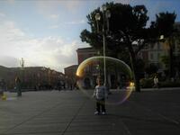 A small girl playing with soap bubble in the downtown of Nice, in the French Riviera /Photo by Ewelina Lepionko
