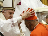 Archbishop Wilton Gregory of Washington, D.C., becomes a cardinal during a ceremony Saturday known as a consistory in St. Peter's Basilica at the Vatican. Pope Francis cautioned new cardinals never to lose their connection to the people. Fabio Frustaci/Pool/AFP via Getty Images