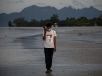 This picture taken on November 16, 2020 shows Rohingya refugee "Abdu Hamid" (using a pseudonym) holding his mobile phone on the Malaysian island of Langkawi, during a video call with his wife who is living at the Kutupalong refugee camp in Ukhia in southern Bangladesh. The video-call app they used to get married in 2017 remains the only means of contact for Julekha and her husband, Abdu Hamid, a Rohingya hotel worker. Mohd RASFAN / AFP
