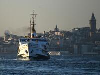A ferry boat sails on the Bosphorus Strait to the Asia side in Istanbul with the Galata tower seen in the background on November 27, 2020. Ozan KOSE / AFP
