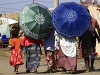 Ethiopian refugees, who fled the fighting in Tigray Region, are pictured walking at a border reception centre (Village 8) in Gedaref State, eastern Sudan, on November 29, 2020. ASHRAF SHAZLY / AFP