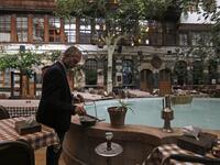 Raed al-Jabri, 61-year-old Syrian, works inside his home-turned-restaurant in the old part of Syria's capital Damascus on November 10, 2020. LOUAI BESHARA / AFP