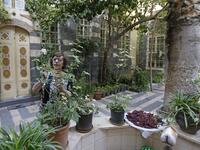 Nahida Mabardi takes care of her heritage house in the old part of Syria's capital Damascus on October 28, 2020. The old city of the Syrian capital is famed for its elegant century-old houses, usually two storeys built around a leafy rectangular courtyard with a carved stone fountain at its centre. While the capital has been largely spared the violence of Syria's almost ten-year war, several of these traditional homes have been abandoned by their owners or damaged in the conflict. LOUAI BESHARA / AFP