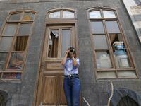Rania Kataf, 35-year-old Syrian, captures images of the city's famed houses for her digital archive in the old part of Syria's capital Damascus on October 28, 2020. The old city of the Syrian capital is famed for its elegant century-old houses, usually two storeys built around a leafy rectangular courtyard with a carved stone fountain at its centre.LOUAI BESHARA / AFP