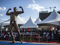 A bodybuilder poses on stage during the Iron Fit Bodybuilding competition in Nairobi on December 05, 2020. 130 participants from all across East Africa took part in the second edition of this competition which included categories like Bikini, Figure, Physique and Bodybuilding. Patrick Meinhardt / AFP