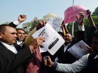 Members of All India lawyers union prepare to burn a copy of the Farmers Acts during a protest in support of the nationwide general strike called by farmers against the recent agricultural reforms in Allahabad on December 8, 2020.  SANJAY KANOJIA / AFP