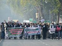 Members of All India lawyers union Acts march along a street during a protest in support of the nationwide general strike called by farmers against the recent agricultural reforms in Allahabad on December 8, 2020. SANJAY KANOJIA / AFP