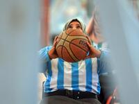 A disabled Yemeni woman prepares to shoot the ball during a local wheelchair basketball championship in Yemen's capital Sanaa on December 8, 2020. In conflict-ridden Yemen, nine teams, including five-all women groups, competed in a local championship for the disabled in the capital Sanaa, which has been under rebel control since 2014. The players are competing to be embraced by society for their strengths rather than be viewed as a burden during the time of war. Mohammed HUWAIS / AFP