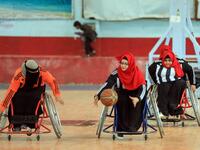 Disabled Yemeni women take part in a local wheelchair basketball championship in Yemen's capital Sanaa on December 8, 2020. In conflict-ridden Yemen, nine teams, including five-all women groups, competed in a local championship for the disabled in the capital Sanaa, which has been under rebel control since 2014. The players are competing to be embraced by society for their strengths rather than be viewed as a burden during the time of war. Mohammed HUWAIS / AFP