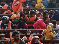 Rohingya refugees sit on a Bangladesh Navy ship as they are relocated to the controversial flood-prone island Bhashan Char in the Bay of Bengal, in Chittagong on December 29, 2020. Rehman ASAD / AFP