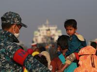 Rohingya refugees embark on a Bangladesh Navy ship as they are relocated to the controversial flood-prone island Bhashan Char in the Bay of Bengal, in Chittagong on December 29, 2020. Rehman ASAD / AFP