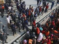 Rohingya refugees disembark from a Bangladesh Navy ship as they are relocated to the controversial flood-prone island Bhashan Char in the Bay of Bengal, in Chittagong on December 29, 2020. REHMAN ASAD / AFP