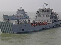 Rohingya refugees are seen on Bangladesh Navy ships as they are relocated to the controversial flood-prone island Bhashan Char in the Bay of Bengal, in Chittagong on December 29, 2020. REHMAN ASAD / AFP