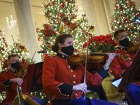A military band plays Christmas music in the Grand Foyer of the White House on November 30, 2020 in Washington, DC. This year's theme for the White House Christmas decorations is "America the Beautiful." Drew Angerer/Getty Images/AFP