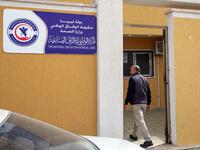 Libyan fishmonger Radwan Jibril enters the National Center for Artificial Limbs for a consultation, in the port city of Misrata, on December 17, 2020. With Libya's health sector left in tatters by its multiple conflicts since the 2011 revolution, war-wounded Libyans are often sent abroad for treatment, at the expense of the state. MAHMUD TURKIA / AFP