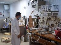 A member of staff works at the National Center for Artificial Limbs, in Libya's port city of Misrata, on December 17, 2020. With Libya's health sector left in tatters by its multiple conflicts since the 2011 revolution, war-wounded Libyans are often sent abroad for treatment, at the expense of the state. However, A national centre for prostheses, being established in Misrata, already has a patient waiting list of more than 3,000 amputees
