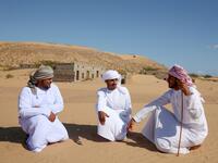 Former inhabitants of Wadi al-Murr, gather near abandoned houses in the Omani village, about 400 kms (250 miles) southwest of the capital Muscat, on December 31, 2020. MOHAMMED MAHJOUB / AFP