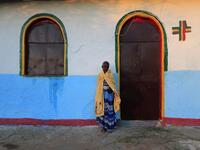 An Ethiopian refugee who fled the Tigray conflict stands outside an Orthodox church built by former Ethiopian refugees, on Coptic Christmas day at a village next to Um Raquba refugee camp in Gedaref, eastern Sudan, on January 6, 2021. ASHRAF SHAZLY / AFP