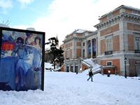 A man walks past the Prado Museum in Madrid on January 10, 2021. Snowstorms in Spain left three people dead and caused chaos across much of the country, trapping motorists and shutting down the capital's air and rail links. Gabriel BOUYS / AFP