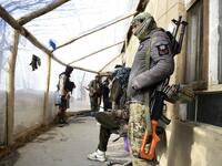 In this photo taken on January 9, 2021, Hazara armed militia for the Resistance for Justice Movement, stand inside their base ahead of a patrol against Taliban insurgents at Hisa-e-Awali Behsud district of Maidan Wardak Province. Comprising roughly 10 to 20 percent of Afghanistan's 38-million population, Hazaras have long been persecuted for their largely Shiite faith by Sunni hardliners in a country wracked by deep ethnic divisions. WAKIL KOHSAR / AFP
