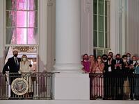 US President Joe Biden (L) and First Lady Jill Biden (2nd L) appear on the Blue Room Balcony as they and family members (R) watch fireworks from the White House in Washington, DC on January 20, 2021. JIM WATSON / AFP