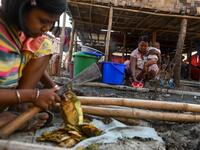 This photo taken on January 11, 2021 shows Chin people preparing food in Bethel village in Hmawbi, on the outskirts of Yangon, where hundreds of members of the Chin ethnic community have settled after being displaced by fighting between Myanmar's military and the Arakan Army in the country's north.  Ye Aung THU / AFP