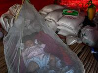This photo taken on January 11, 2021 shows a Chin baby sleeping under a mosquito net in Bethel village in Hmawbi, on the outskirts of Yangon, where hundreds of members of the Chin ethnic community have settled after being displaced by fighting between Myanmar's military and the Arakan Army in the country's north.  Ye Aung THU / AFP