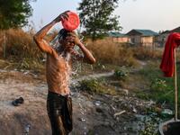 This photo taken on January 11, 2021 shows a Chin man washing in Bethel village in Hmawbi, on the outskirts of Yangon, where hundreds of members of the Chin ethnic community have settled after being displaced by fighting between Myanmar's military and the Arakan Army in the country's north.  Ye Aung THU / AFP