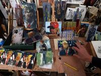 Israeli painter Iddo Markus arranges his paintings of former US president Donald Trump, at his studio in the northern port city of Haifa, on January 22, 2021. Markus became fascinated by the "tragic figure" of Donald Trump, and the walls and floor of his studio are packed with some 120 portraits of the former US presidents. Emmanuel DUNAND / AFP