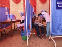 A health worker receives a dose of Covishield, AstraZeneca-Oxford's COVID-19 coronavirus vaccine made by local partner Serum Institute of India, at Patan Hospital near Kathmandu on January 27, 2021. PRAKASH MATHEMA / AFP