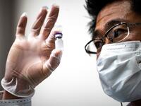 A medical personnel presents a containers with water, which are used to preserve the vaccinnes in a deep freezer during a Covid-19 coronavirus vaccination drill at the Kawasaki City College of Nursing in Kawasaki on January 27, 2021. Philip FONG / AFP