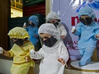 View of dolls displayed for sale at the ¨Nino Uribe¨ traditional Mexican store in Mexico City on January 27, 2021. ¨Nino Uribe¨ sells representations of the Baby Jesus called Baby COVID to raise awareness on the preventive measures to take amid the COVID-19 coronavirus pandemic. CLAUDIO CRUZ / AFP