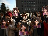 A group of Myanmar activists hold the portrait of Aung San Suu Kyi during a protest outside the United Nation university in Tokyo on February 1, 2021 following a military coup in the country by a general after arresting civilian leader Aung San Suu Kyi and other senior officials. Philip FONG / AFP