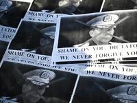 Images of Myanmar's military chief General Min Aung Hlaing are pictured as a group of Myanmar activists protest outside United Nations University building in Tokyo on February 1, 2021, following a military coup in the country after arresting civilian leader Aung San Suu Kyi and other senior officials. Philip FONG / AFP