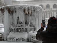 A person takes a picture of The Josephine Shaw Lowell Memorial Fountain covered in ice during a winter storm on February 1, 2021 in New York City. A powerful winter storm is set to dump feet of snow along a stretch of the US east coast including New York City on February 1, 2021, after blanketing the nation's capital. Angela Weiss / AFP