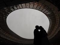 Newlyweds kiss during their wedding ceremony at the Luzhniki stadium in Moscow on February 12, 2021, days before Valentine's Day. NATALIA KOLESNIKOVA / AFP