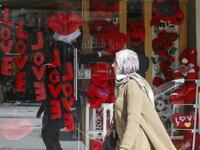 A Palestinian shopkeeper arranges gifts in a window on the eve of Valentine's Day at a shop in Hebron city, in the occupied West Bank, on February 13, 2021. HAZEM BADER / AFP