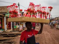 A street vendor sells artificial red flowers for the Valentine's day, in Kampala, on February 13, 2021. Badru KATUMBA / AFP