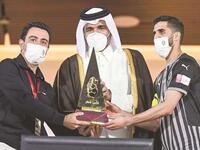 Sheikh Joaan bin Hamad al-Thani presents the Qatar Cup trophy to Al Sadd captain Hassan al-Haydos (right) and coach Xavi Hernandez (left). (Photo: Noushad Thekkayil)
