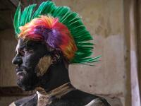 A carnival participant dressed in costume and wearing body paint