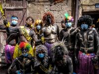 Carnival participants dressed in costume and wearing body paint pose for a group picture during the annual Zambo carnival held in Lebanon