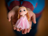 Yara, 10 years, holds a doll in Za’atari Refugee Camp.