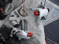 Rope access technicians work on a damaged vault of the Notre-Dame de Paris Cathedral 