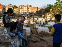 hildren argue by a grave in the Ghoraba (Strangers) cemetery, named after the neighbourhood where it is situated in Lebanon's northern port city of Tripoli 