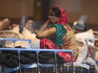 A patient rests inside a banquet hall temporarily converted into a Covid-19 coronavirus ward in New Delhi 